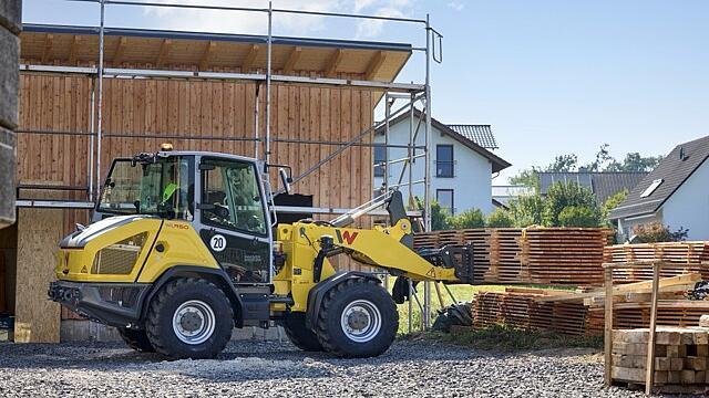 Wheel loader moving wood