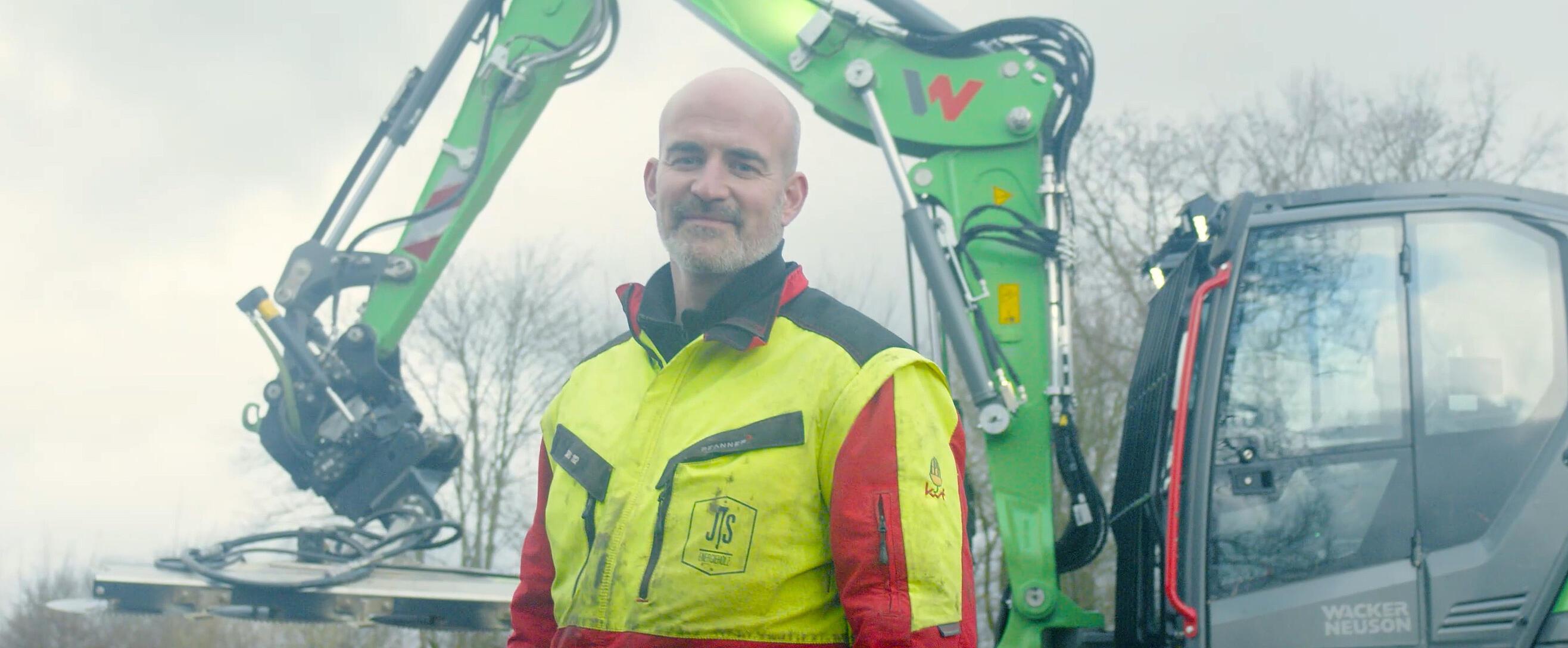 man standing in front of excavator